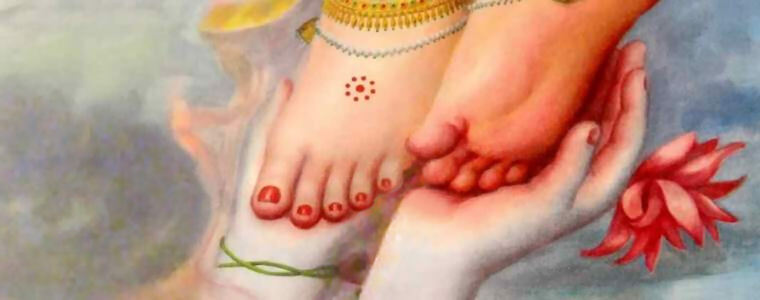 Krishna's lotus feet held in Radha's hands beside an offered lotus flower — a devotional image evoking the dehi pada-pallavam udaram verse of the Gita Govinda.