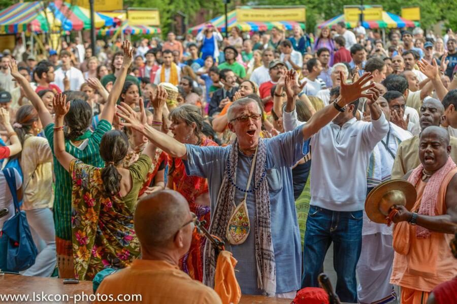 A present-day ISKCON kirtan/festival gathering, with devotees dancing and chanting in a public park - the movement Srila Prabhupada founded, continuing today. (Does not depict Srila Prabhupada himself.)