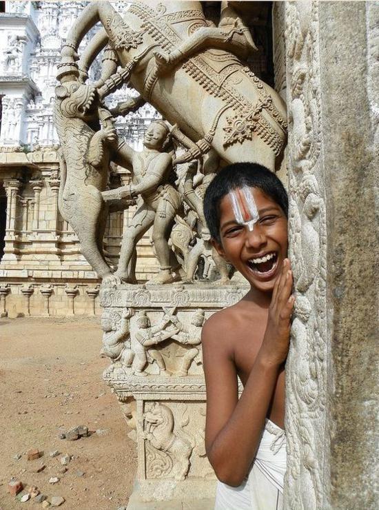 A young Sri Vaishnava resident of Srirangam, Tamil Nadu, photographed before the carved gopuram of the Sri Ranganathaswamy temple - the same temple town where Prabodhananda Saraswati and his brothers served as Sri Vaishnava priests before t